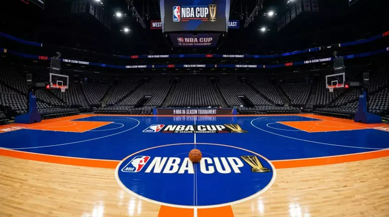 Indoor NBA-style hardwood court painted with the bright bespoke Cup-night colours under arena lights, basketball resting on the half-court line